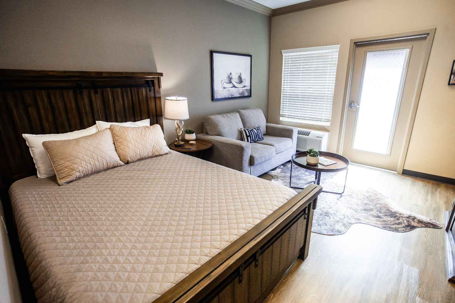 A furnished private bedroom and sitting area in a Cathedral Life Centre residence